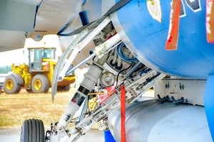View of a plane's deployed landing gear hydraulics