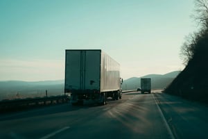 Freight truck driving away in a mountainous landscape