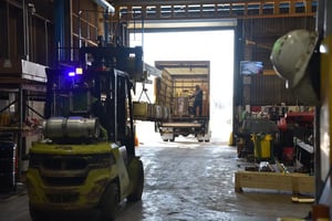 Wood crate being loaded onto a freight truck in Sullivan Steel's warehouse