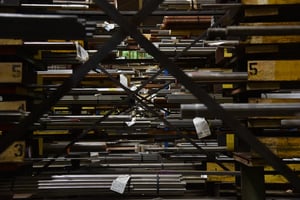 Steel bars in yellow pans in a warehouse