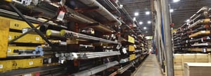Sullivan Steel warehouse aisle with racks and pans holding steel bar and tube