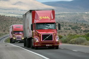 Red Saia freight truck driving on a desert road