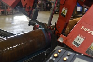 Red HFA saw cutting through a large steel tube