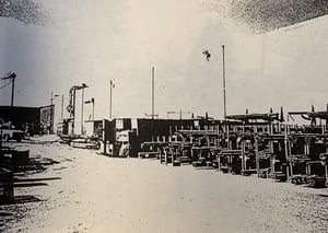Photograph of old warehouse racks holding steel bar and tube