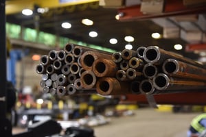 Various steel tube sizes displayed on a Sullivan Steel warehouse rack